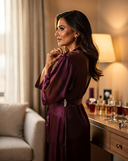 Woman fastening an evening dress near a vanity, dressing ritual