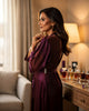 Woman fastening an evening dress near a vanity, dressing ritual