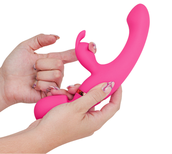 Pink USB rechargeable massager with a white cable on a white background.